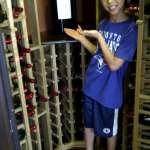 Benjamin in wine cellar w Huge Barolo